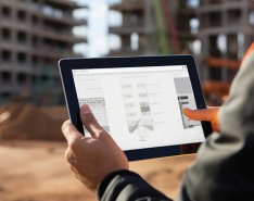 Worker in vest holding tablet