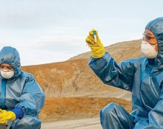 Workers in PPE/Adobe Stock