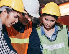 Three workers in vests and hard hats