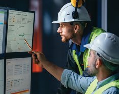 two construction workers looking at chart